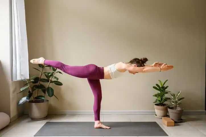 Woman doing Yoga exercise Weybridge to help with toning the body. 