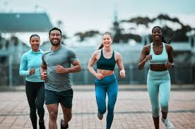 Sculpting Sleek Arms: The Essential Role of Cardio in Toning Without Bulking Up 3 image of people running to incorporate cardio Weybridge exercise into their life to help tone arms and body.
