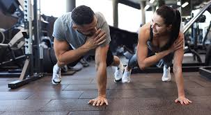 Image of man and woman doing Cardio Weybridge to tone their arms. 